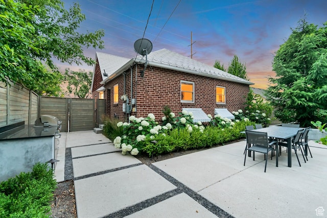 1221 E 800 S, Salt Lake City, UT 84102 - rear view of house featuring brick siding, a gate, a patio area, and outdoor dining space