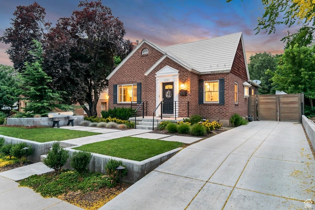 1221 E 800 S, Salt Lake City, UT 84102 - bungalow-style house with brick siding, concrete driveway, and a gate