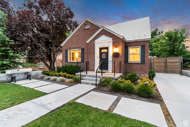 1221 E 800 S, Salt Lake City, UT 84102 - bungalow-style house with brick siding, concrete driveway, and a gate