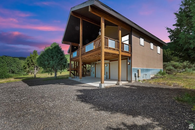1674 S Cottonwood Ct Unit 1217, Heber City, UT 84032 - back of property at dusk featuring driveway, a garage, and stairs