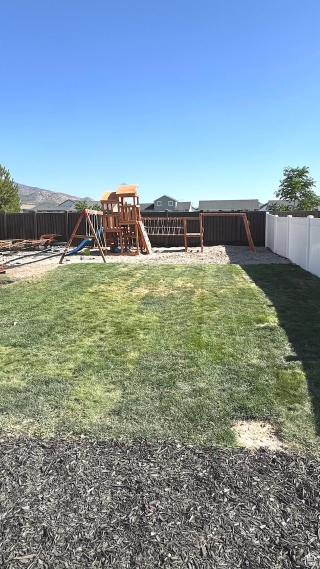 2408 E Maple Dr, Eagle Mountain, UT 84005 - fenced backyard with a playground