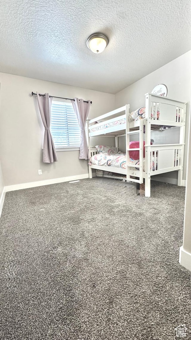 2408 E Maple Dr, Eagle Mountain, UT 84005 - carpeted bedroom featuring a textured ceiling and baseboards
