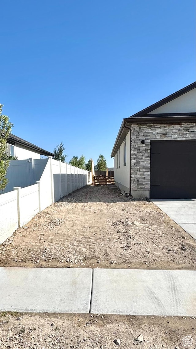 2408 E Maple Dr, Eagle Mountain, UT 84005 - view of yard featuring a garage and driveway