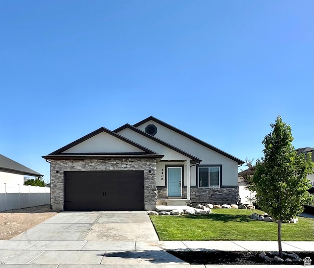 2408 E Maple Dr, Eagle Mountain, UT 84005 - view of front of property with an attached garage, stucco siding, concrete driveway, and stone siding