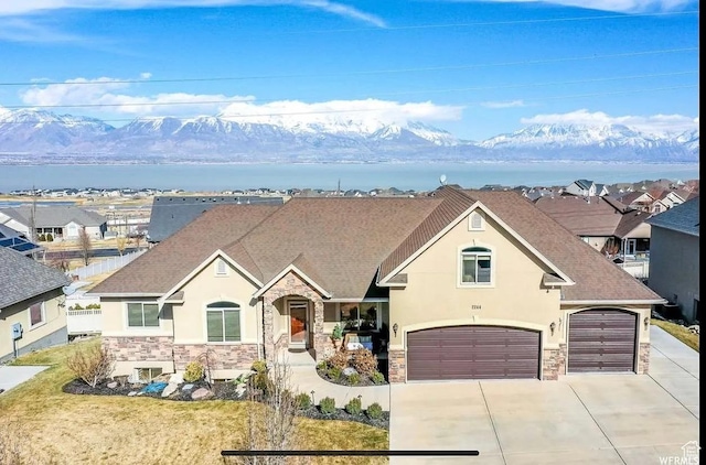 2244 S Hunter Dr, Saratoga Springs, UT 84045 - view of front of property featuring stone siding, stucco siding, concrete driveway, and a shingled roof