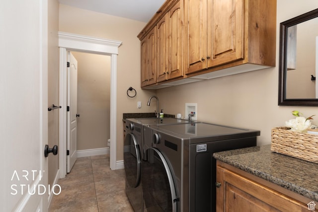 2244 S Hunter Dr, Saratoga Springs, UT 84045 - laundry area with cabinet space, washer and clothes dryer, and light tile patterned floors
