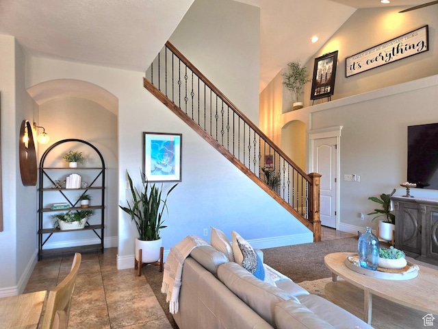 2244 S Hunter Dr, Saratoga Springs, UT 84045 - living room featuring stairway, high vaulted ceiling, and arched walkways