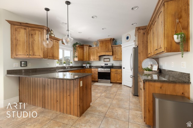 2244 S Hunter Dr, Saratoga Springs, UT 84045 - kitchen with stainless steel appliances, a peninsula, brown cabinetry, hanging light fixtures, and light tile patterned floors