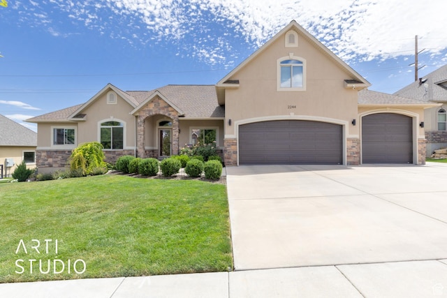 2244 S Hunter Dr, Saratoga Springs, UT 84045 - view of front of home with stucco siding, a front yard, stone siding, concrete driveway, and a shingled roof