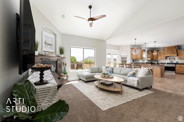 2244 S Hunter Dr, Saratoga Springs, UT 84045 - living room featuring ceiling fan, a glass covered fireplace, high vaulted ceiling, and light carpet