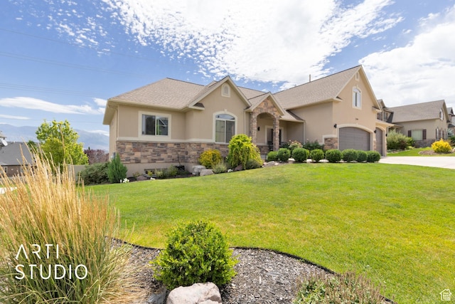 2244 S Hunter Dr, Saratoga Springs, UT 84045 - view of front of property featuring stone siding, stucco siding, an attached garage, driveway, and a front yard