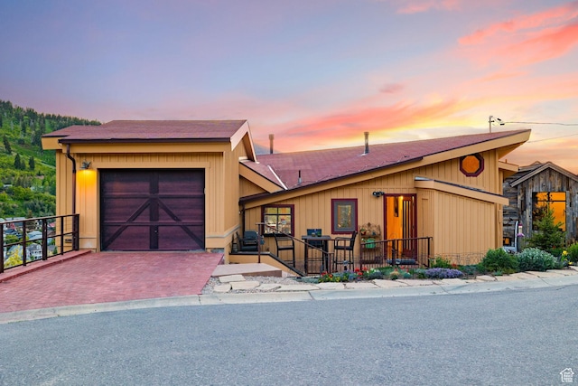 235 Mchenry Ave, Park City, UT 84060 - view of front of house featuring a garage, a shingled roof, and decorative driveway