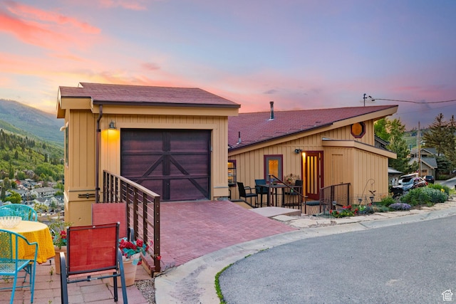 235 Mchenry Ave, Park City, UT 84060 - view of front of house with a garage, decorative driveway, a mountain view, and a patio area
