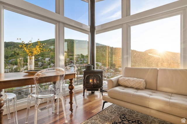 235 Mchenry Ave, Park City, UT 84060 - sunroom / solarium featuring a wood stove, wood finished floors, and a mountain view