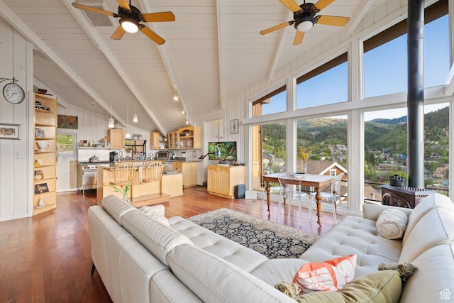 235 Mchenry Ave, Park City, UT 84060 - living area with ceiling fan, wood-type flooring, a wood stove, a wooden ceiling with exposed beams, and high vaulted ceiling