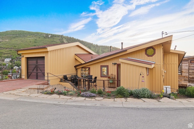 235 Mchenry Ave, Park City, UT 84060 - view of front of house featuring a mountain view, a garage, and decorative driveway