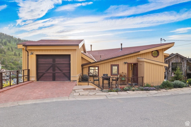 235 Mchenry Ave, Park City, UT 84060 - view of front of home with an attached garage, decorative driveway, and a shingled roof