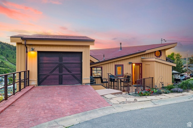 235 Mchenry Ave, Park City, UT 84060 - view of front of home with an attached garage, decorative driveway, and a shingled roof
