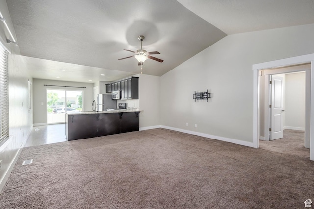 1728 E Shadow Dr, Eagle Mountain, UT 84005 - unfurnished living room with ceiling fan, vaulted ceiling, and light colored carpet