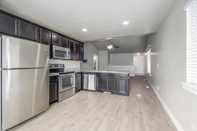 1728 E Shadow Dr, Eagle Mountain, UT 84005 - kitchen with appliances with stainless steel finishes, a peninsula, a ceiling fan, light wood-style flooring, and light countertops
