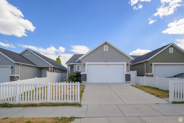 1728 E Shadow Dr, Eagle Mountain, UT 84005 - view of front of property featuring stucco siding, a garage, concrete driveway, and stone siding