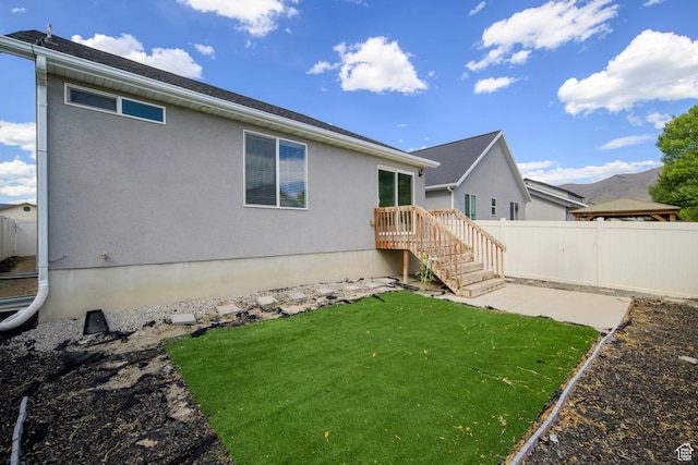 1728 E Shadow Dr, Eagle Mountain, UT 84005 - back of property featuring a patio area and stucco siding