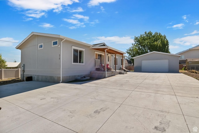 516 N Broadway Ave, Tooele, UT 84074 - view of front of home with a detached garage, an outbuilding, and covered porch