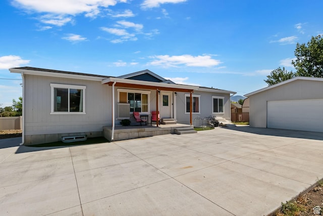 516 N Broadway Ave, Tooele, UT 84074 - view of front of house with covered porch, an outdoor structure, and a detached garage