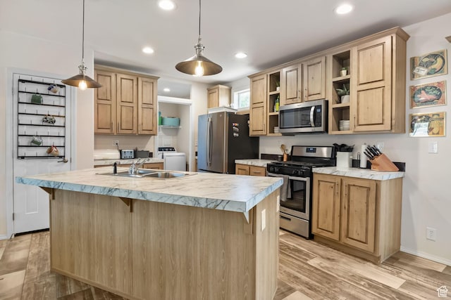516 N Broadway Ave, Tooele, UT 84074 - kitchen with appliances with stainless steel finishes, open shelves, washer / clothes dryer, light countertops, and a kitchen bar