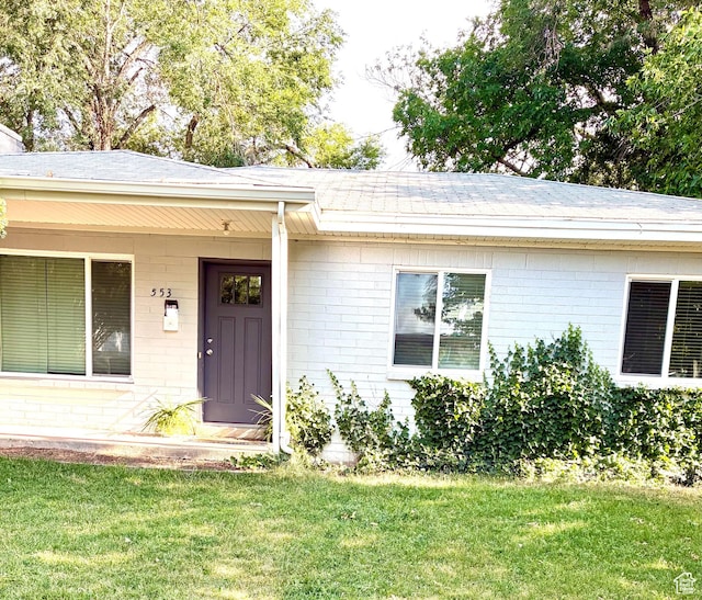 553 Clark St, Woods Cross, UT 84010 - entrance to property featuring brick siding, a yard, and a shingled roof