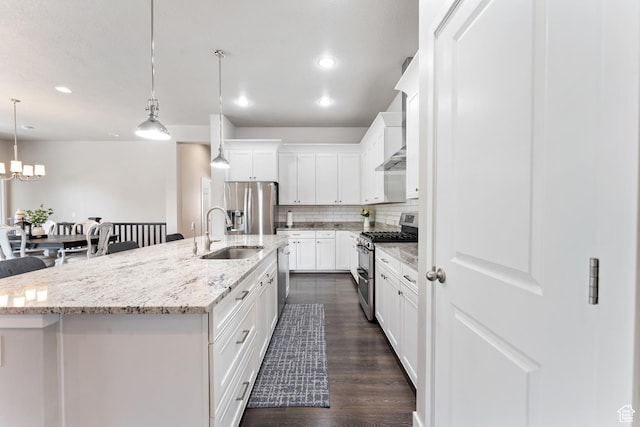 3301 W Cramden Dr, Lehi, UT 84043 - kitchen with stainless steel appliances, a center island with sink, dark wood finished floors, backsplash, and white cabinets