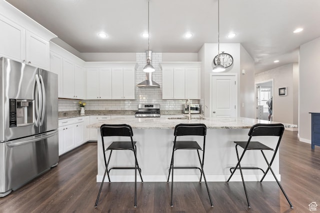 3301 W Cramden Dr, Lehi, UT 84043 - kitchen featuring appliances with stainless steel finishes, dark wood-type flooring, white cabinetry, tasteful backsplash, and a kitchen bar