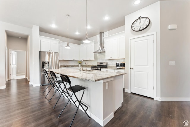 3301 W Cramden Dr, Lehi, UT 84043 - kitchen featuring appliances with stainless steel finishes, wall chimney exhaust hood, backsplash, a center island with sink, and a breakfast bar area