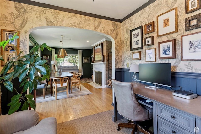 93 S 200 E, Kaysville, UT 84037 - home office with wallpapered walls, arched walkways, a wainscoted wall, light wood finished floors, and a fireplace with flush hearth