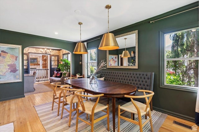 93 S 200 E, Kaysville, UT 84037 - dining space with healthy amount of natural light, arched walkways, ornamental molding, a chandelier, and hardwood / wood-style flooring