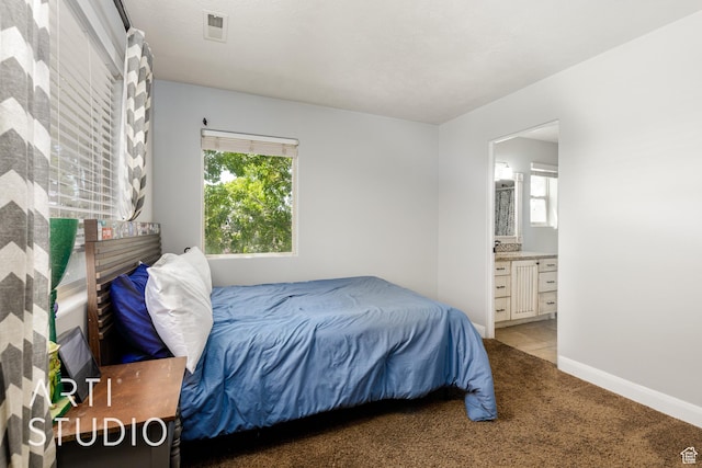 94 S 6175 W, Hurricane, UT 84737 - bedroom featuring light carpet, multiple windows, and connected bathroom