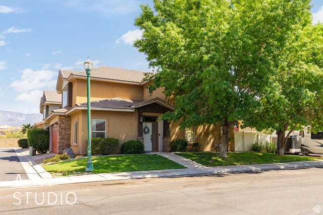 94 S 6175 W, Hurricane, UT 84737 - view of front of house featuring stucco siding, a tile roof, stone siding, and driveway
