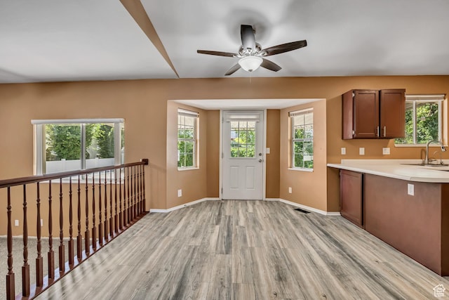 2331 W 13190 S, Riverton, UT 84065 - kitchen with light wood finished floors, light countertops, ceiling fan, and plenty of natural light