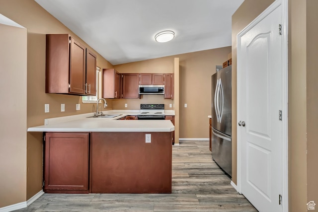 2331 W 13190 S, Riverton, UT 84065 - kitchen with appliances with stainless steel finishes, lofted ceiling, light wood finished floors, a peninsula, and light countertops