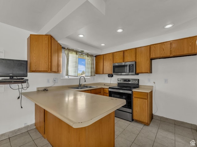 3112 W 5685 S, Taylorsville, UT 84129 - kitchen featuring stainless steel appliances, a peninsula, brown cabinetry, light countertops, and recessed lighting
