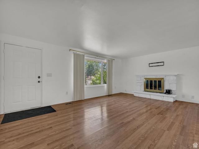 3112 W 5685 S, Taylorsville, UT 84129 - unfurnished living room featuring wood finished floors and a glass covered fireplace