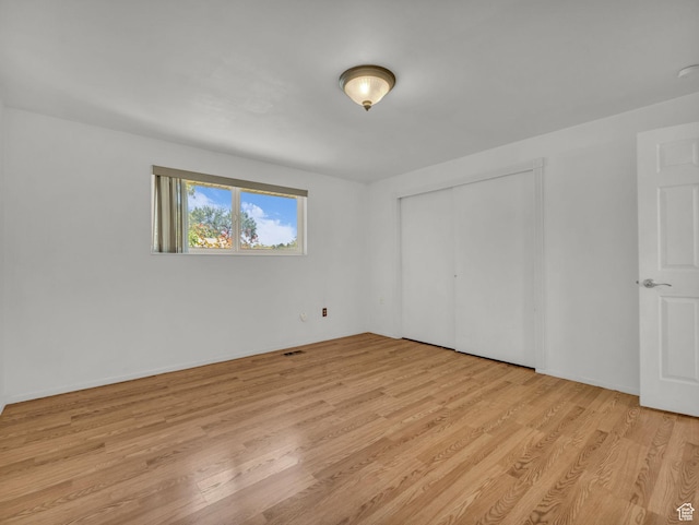 3112 W 5685 S, Taylorsville, UT 84129 - unfurnished bedroom with light wood-type flooring and a closet