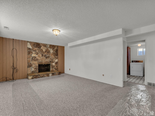 3112 W 5685 S, Taylorsville, UT 84129 - unfurnished living room with washer / clothes dryer, a textured ceiling, and a fireplace