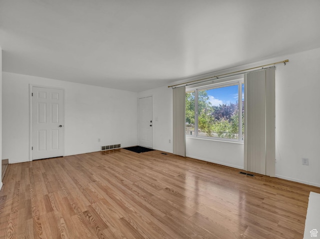 3112 W 5685 S, Taylorsville, UT 84129 - unfurnished living room featuring light wood-type flooring
