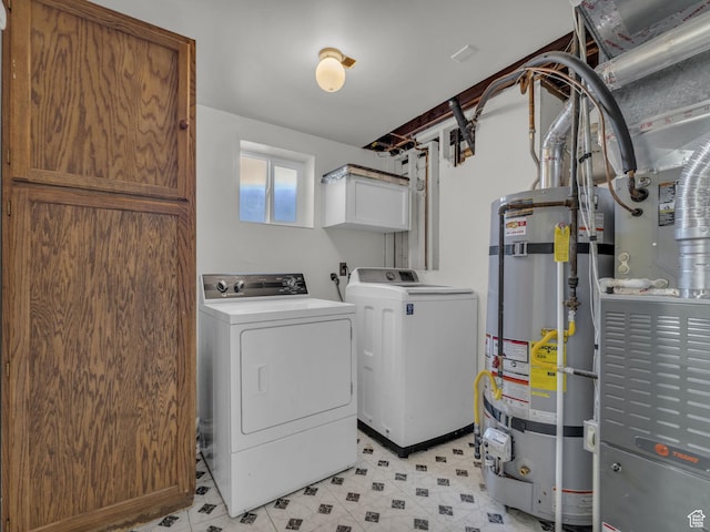 3112 W 5685 S, Taylorsville, UT 84129 - washroom featuring strapped water heater, washer and dryer, light floors, and cabinet space