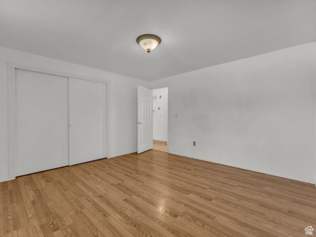 3112 W 5685 S, Taylorsville, UT 84129 - unfurnished bedroom featuring wood finished floors and a closet
