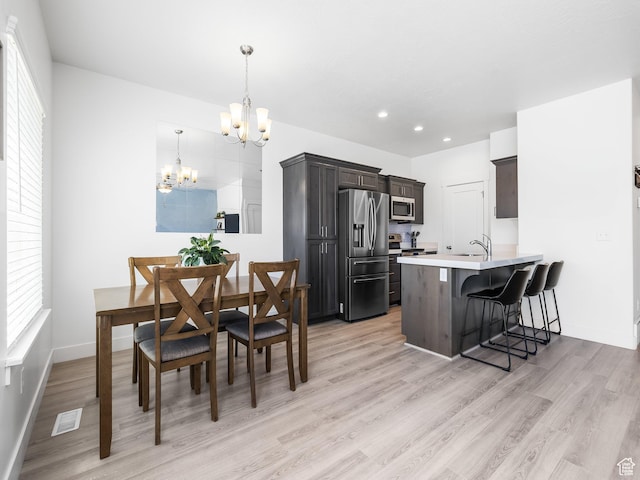 5084 E Lakefield Dr E, Eagle Mountain, UT 84005 - dining area featuring a chandelier, light wood-type flooring, healthy amount of natural light, and recessed lighting