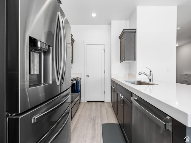 5084 E Lakefield Dr E, Eagle Mountain, UT 84005 - kitchen featuring appliances with stainless steel finishes, light countertops, light wood finished floors, and recessed lighting