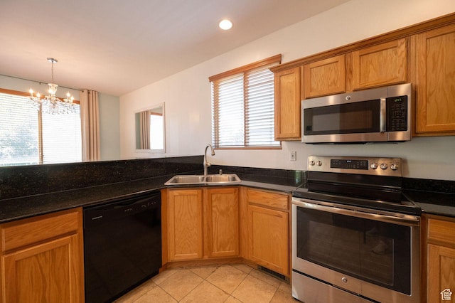 1879 W 2250 N, Lehi, UT 84043 - kitchen featuring appliances with stainless steel finishes, light tile patterned floors, a chandelier, brown cabinetry, and recessed lighting