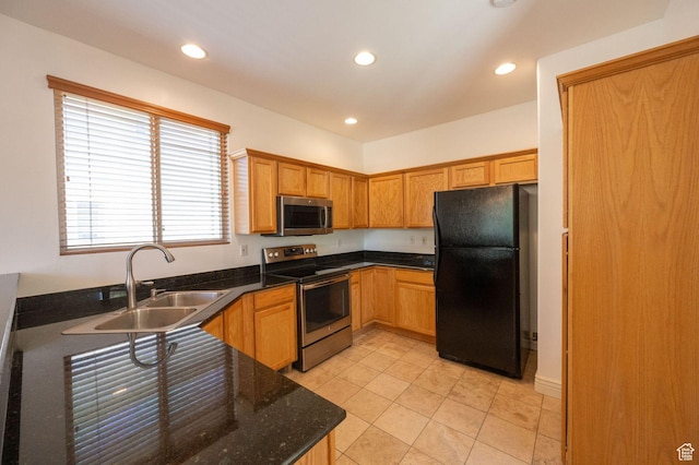 1879 W 2250 N, Lehi, UT 84043 - kitchen with appliances with stainless steel finishes, recessed lighting, light tile patterned flooring, dark stone counters, and brown cabinetry